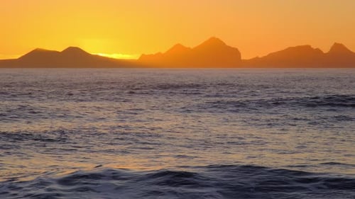 Sunrise Over Stormy Sea Shining Golden Waves with Sun Reflection
