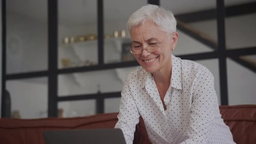 Middle Age Teacher Working on Laptop and Smiling Close Up