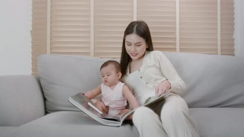 Mother and Baby Reading Picture Book at Home