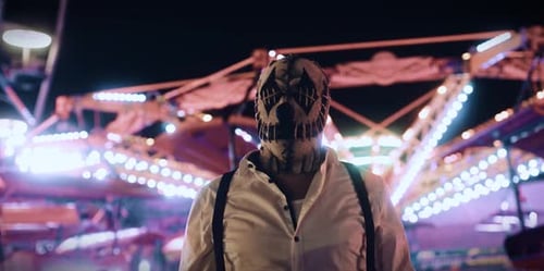 Creepy Masked Man at Amusement Park at Night