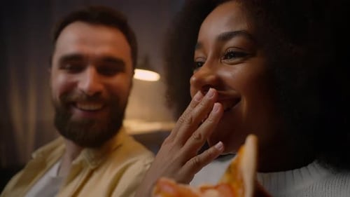 Closeup Romantic Diverse Couple Eating Pizza and Watching Comedy on Tv