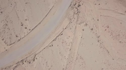 Desert landscape with narrow trail crossing the frame