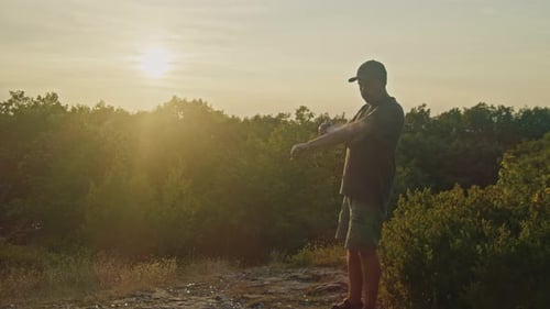 Sunset Protection Man Sprays Mosquito Repellent on Mountain