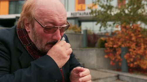 Man Blows Nose With Tissue Outdoors