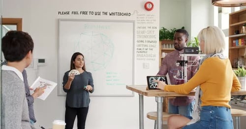 Diverse Team Collaborating on Project in Modern Office