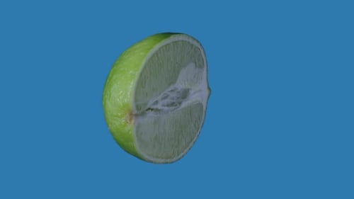 Half Lime Rotating Slowly on a Blue Background