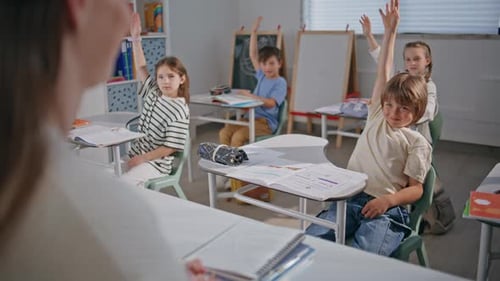 Enthusiastic Children Raising Hands in Class