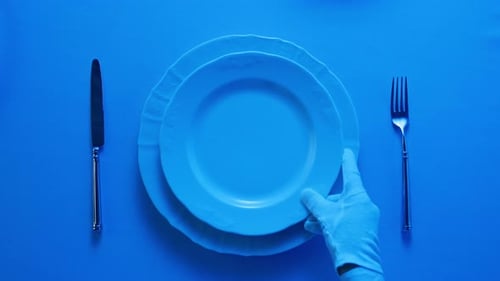 Gloves Stacking Plates on Blue Table Setting