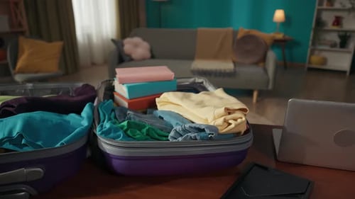 Suitcases Packed With Clothing in Living Room