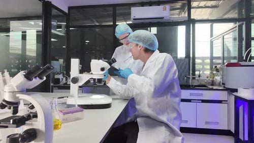 Medical professionals analyze test results in a laboratory setting during a busy workday