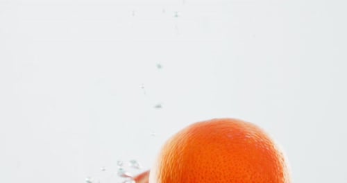 Fruit, orange and water with vitamin c for nutrition, fresh produce or hydration in studio