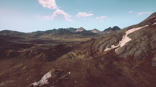 An Aerial View of a Mountain Range with a Sky Background