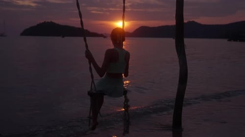 Zoom In Shot Of Girl On A Swing