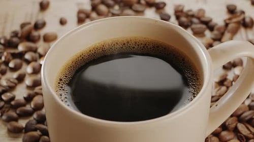 Coffee Cup with Roasted Beans Close Up