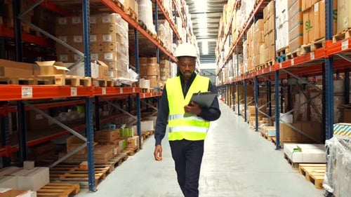 Logistics Operator Walking Through Warehouse