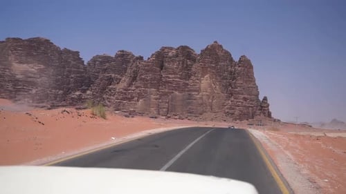 Driving in Desert on Asphalt Road With View of Sandstone Cliff and Dry Landscape on Hot Sunny Day, P