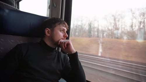 Handsome Young Man Looks Thoughtfully Out Window During Train Ride Traveling Helps you Reboot Unwind
