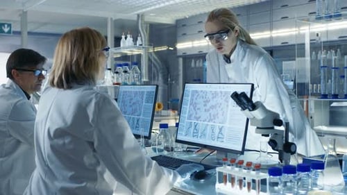 Scientists collaborating on research in modern laboratory