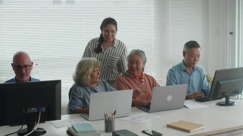 Adults and Seniors Learning Computers in a Workplace