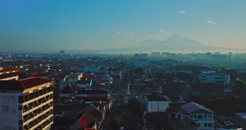 Yogyakarta, 17 July 2023, Aerial view of the city in the morning with a mountain background