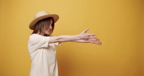 Young Woman Gesturing on a Yellow Background