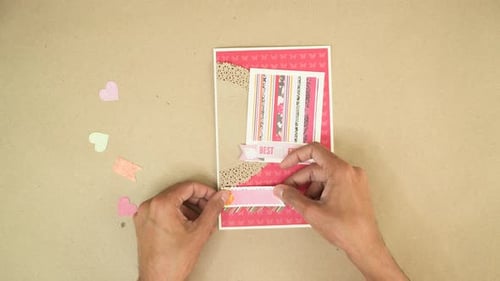 Hands Crafting a Decorative Greeting Card