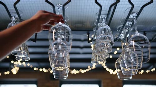 Clean Wine Glasses Hanging Upside Down a Bar Rack in Restaurant