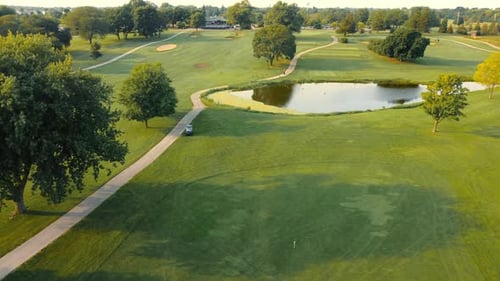 Beautiful Golf Course with Green Grass Trees Lake on a Sunny Day Aerial View of a Green Golf Course