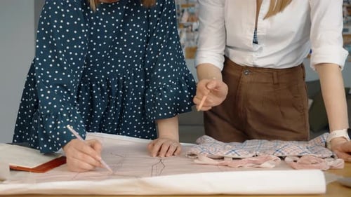 Fashion Designers Collaborating on a New Garment