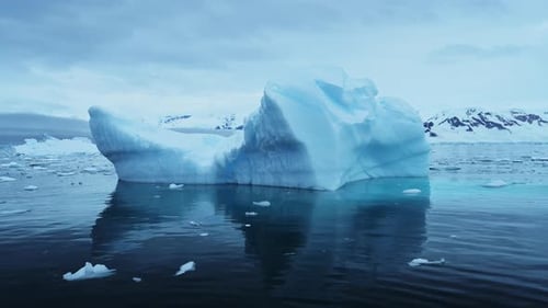 Stunning Blue Iceberg Floating Peacefully In The Calm Antarctic Ocean