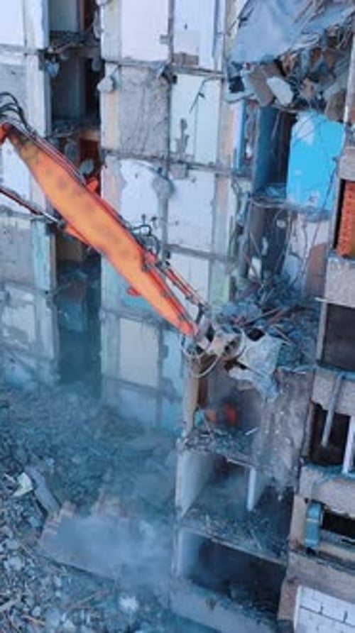 Ruined building is being demolished with the help of special machinery