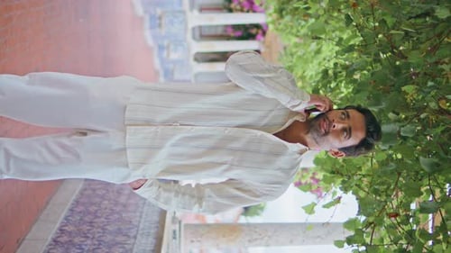 Handsome Guy Calling Cellphone at City Balcony Vertically Macho Talking Phone