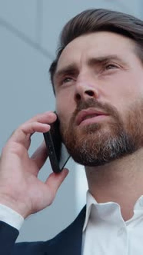 Serious Caucasian Business Man Talking Mobile Phone in City Outdoors Confident Businessman Discuss