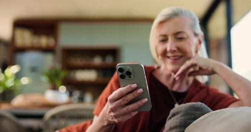 Senior Woman Relaxing at Home Using Smartphone