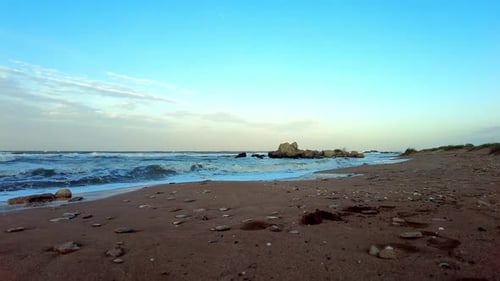 Relaxing beach day with gentle waves and clear sky at a tranquil coastal location