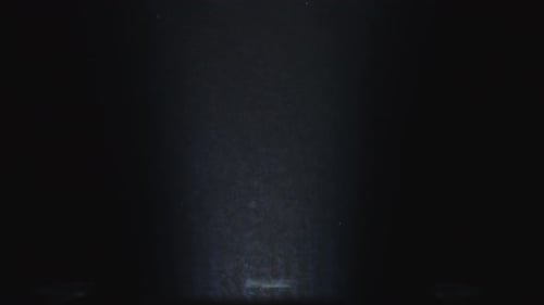 Flow Stage of Formless Smoke Swirling Against a Black Background