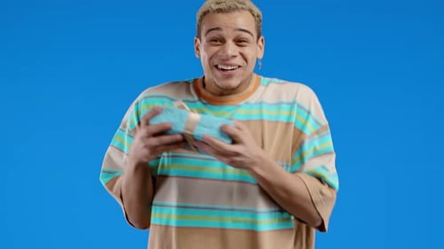 Excited Young Adult Holding a Birthday Gift