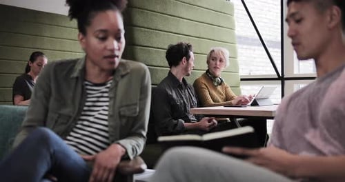 Adults Gather in Modern Office for Business Discussion