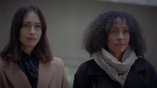 Lifestyle Portrait of Two Young Women Watching Tower Building Together