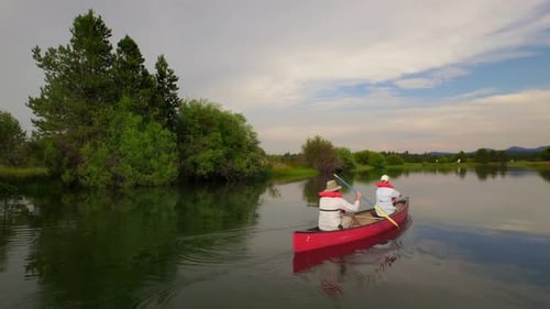 People Ride Kayak Under Sunset Sky by Green Forest Active People