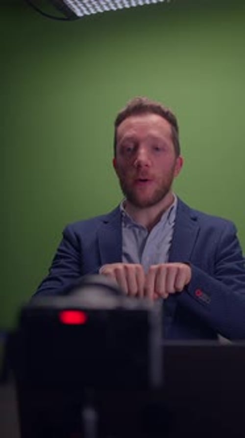Professional Speaker Presenting in a Studio Setting Utilizing a Green Screen for Effects