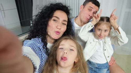 Family Posing for Selfie in Home, Making Faces