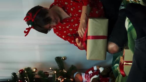 Christmas Morning: Family Opening Presents by Tree