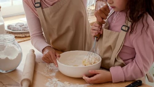Mother and Daughter Baking Together in a Warm Family Kitchen