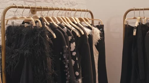 Fancy Black Outfits on Racks in Expensive Clothes Store