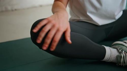 Woman Stretching on Yoga Mat in Home