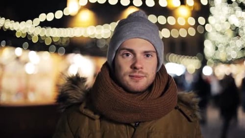 Smiling Man with Winter Hat at Christmas Market