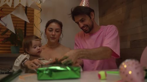 Family Celebrates a Birthday with Gift Opening