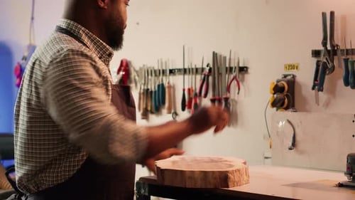 Craftsman with Circular Wood Piece Puts on Safety Glasses