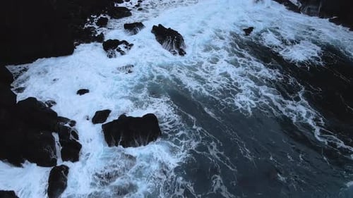 Aerial Seascape South Coast of Iceland. Waves Crashing to Black Rocks on Shore